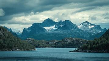 Misty mountains rise above the still water in this scenic landscape, promising adventure and tranquility in a natural setting. photo