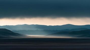 Misty valley beneath a brooding sky, layers of hills fading into the horizon, creating a tranquil landscape. Nature's grand vista. photo