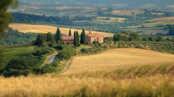Picturesque Tuscan farmhouse nestled amidst rolling golden fields, cypress trees, and vineyards under a soft, hazy sky, evoking serenity. photo