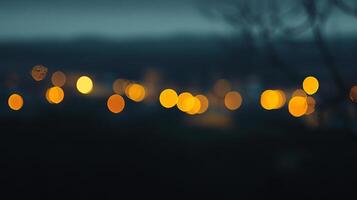 A bokeh photograph of a cityscape glows with warm lights against the fading twilight sky, creating a peaceful atmosphere. photo