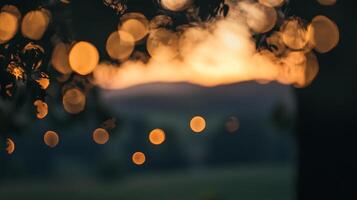 Dreamy lights illuminate the night, creating a magical ambiance with a blurred sunset backdrop. The image evokes warmth and serenity. photo