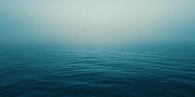 Ocean vista showing rippling water fading into a soft, hazy horizon, exuding tranquility and mystery. The cool color palette enhances mood. photo