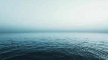 Serene ocean view with gentle ripples and a soft, muted color palette, offering a sense of tranquility and vastness. Blue seascape. photo