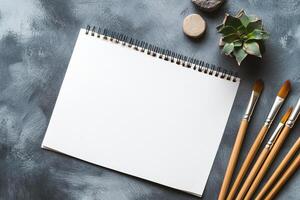 Blank sketchbook ready for creative expression, surrounded by art supplies, offering space for artistic projects and design explorations. photo