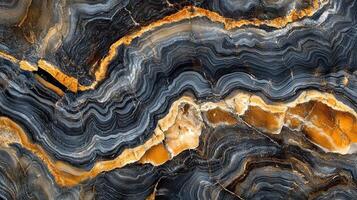 Striated rock formation. Flowing waves of mineral deposits create a beautiful layered pattern with gold accents. Natural stone texture. photo