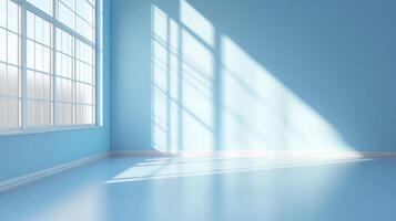 Sunlight streams through a window, casting bright shadows on the pale blue walls and floor of an otherwise empty room. photo