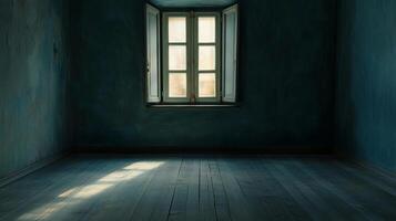 An empty room with blue walls and wood floors is lit by sunlight through a window. The starkness gives an aura of simplicity and calm. photo