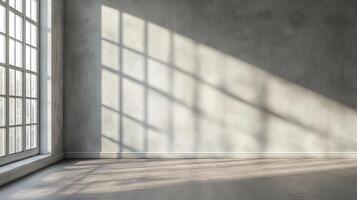 Sunlight streams through a large window, creating a captivating play of light and shadow on a textured wall and wooden floor. photo