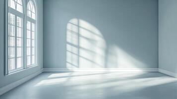 Sunlight streams through arched windows, casting shadows on the cool blue walls and floor of this empty room creating a serene atmosphere. photo