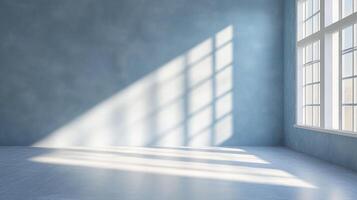 Sunlight streams through the window, creating geometric patterns on the light blue wall and floor of the empty room, a calm and serene space. photo