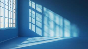 Sunlight streams through a paneled window, casting geometric shadows in a monochrome blue room, creating a serene atmosphere. photo