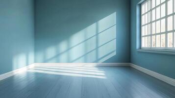 Light streams into an empty, light blue room with wooden floors, creating patterns. A window is on the right wall. photo