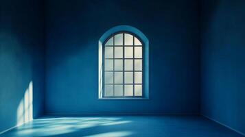 Blue room with light streaming through arched window, creating shadows and highlights for a serene, contemplative atmosphere. photo