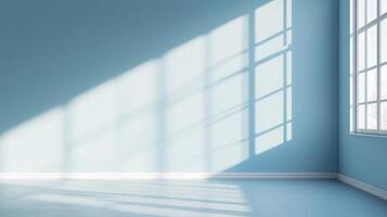 Illuminated room showcases light patterns cast by window panes. Light dances across the cool blue walls and floor, creating shapes. photo