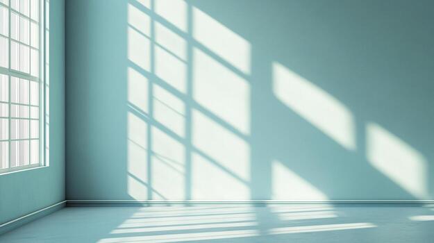 Sunlight streams through a window onto the turquoise wall and floor of a minimal room, creating geometric light and shadow patterns. photo