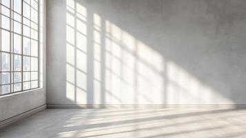 Sunlight streams through the large windows of an empty industrial loft. The room features clean white walls and concrete floors. photo