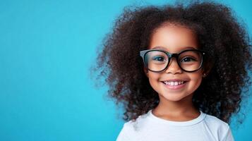 Smiling child wearing glasses against a bright blue backdrop, radiating happiness and innocence with their warm and cheerful expression. photo