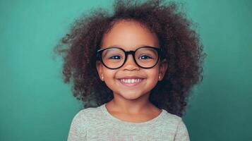 Smiling child with curly hair and glasses. She is happy and healthy. A joyful expression and cute appearance bring charm to the frame. photo