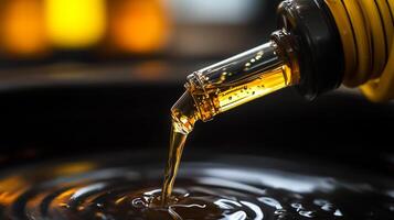 Liquid gold pours smoothly. Viscous fluid creating ripples in a dark pool. Suggests lubrication, energy, or a smooth transition. photo