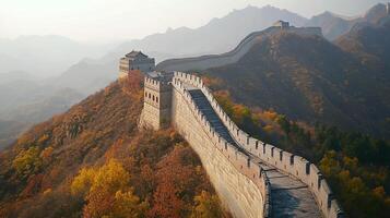 Scenic view of a stone fortification structure snaking across hills and mountains shrouded in mist, surrounded by colorful autumn foliage. photo