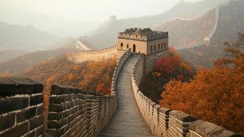 Scenic view of a historic fortification winding through autumn foliage-covered mountains under a misty sky. photo
