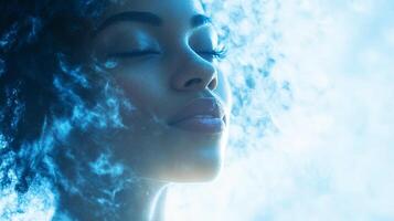 Serene portrait of a woman with closed eyes, bathed in soft blue light and ethereal, cloud-like effects creating a dreamy atmosphere. photo