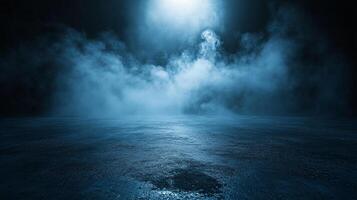 Dark sky with a blue haze and a light shining on it. The light is coming from the sky and is illuminating the ground photo