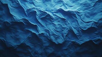 Abstract image of flowing deep blue fabric, folds, and textures creating a dynamic visual experience. Darker shades offer depth and contrast. photo