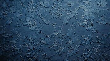 Deep blue textured surface displaying ornate floral and foliate pattern relief. Refined design creates elegant visual interest and depth. photo