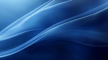 Elegant abstract blue waves flow smoothly across the frame, creating a dynamic sense of movement and depth in cool tones and soft light. photo