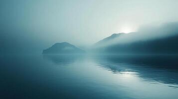 Misty lake scene with tranquil water reflecting mountains shrouded in fog, creating a serene, ethereal atmosphere. Nature's beauty abounds. photo