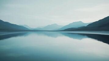 Serene mountain lake reflecting the sky, creating a peaceful, natural scene with soft colors and gentle reflections. photo