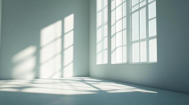 Sunlight streams into a minimalist room through a large window, creating patterns on the floor and wall, emphasizing clean lines and simplicity. photo