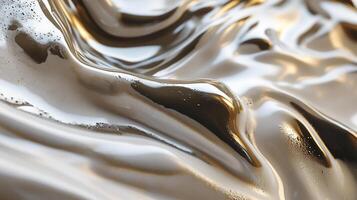 Abstract shiny liquid forms a unique wave pattern, illuminated with gold and silver light, creating a flowing metallic surface. photo