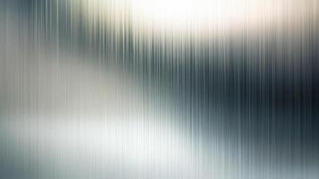 Abstract image with a blurred effect, showing a silver and gray gradient with a vertical, striated texture, resembling brushed metal. photo