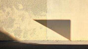 Abstract scene featuring a rough-textured wall, a smooth wall, and a geometric shadow casting a stark shape against them in warm sunlight. photo