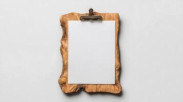 A clipboard with a blank piece of paper hanging on it photo