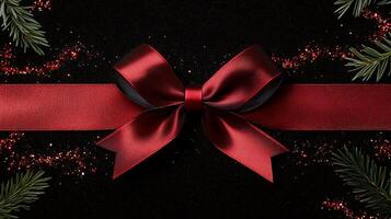 A red ribbon and bow on a black background photo