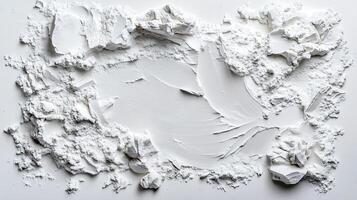 A white wall with a large piece of white paint photo