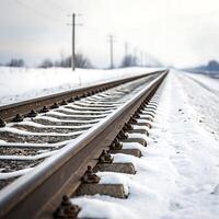 Long railway tracks extending into the distance under a cloudy sky, with snow covering the ground and a minimalist white backdrop photo