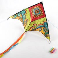 Brightly colored kite with dynamic swirls and ribbons flying against a clear sky, representing freedom and joy photo