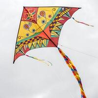 Colorful kite soaring in the sky, with vibrant patterns and ribbons, perfect for a fun and lively outdoor activity photo
