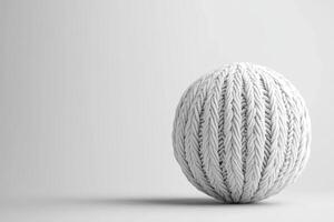 A knitted sphere on a white surface photo