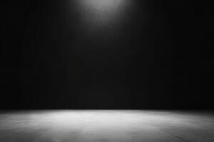 An empty dark room with a spotlight illuminating the floor photo