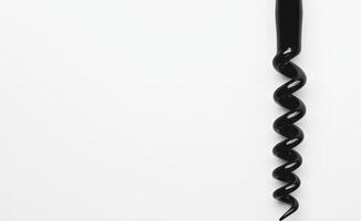Spiral corkscrew tool on a plain background photo