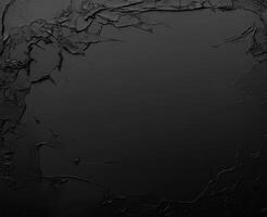 Close up view of a dark surface featuring various cracks and textures photo