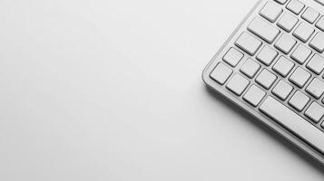 Minimalist gray keyboard placed on a light surface in modern workspace photo