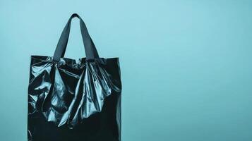 Stylish black bag against a turquoise background showcases minimalism photo