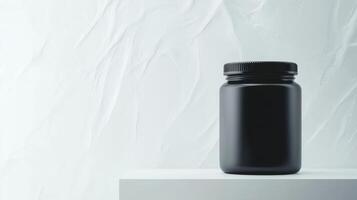 Modern black jar sits elegantly on a white surface with texture photo