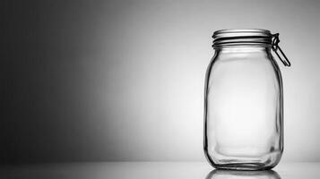 Empty glass jar with metal clasp on white surface photo
